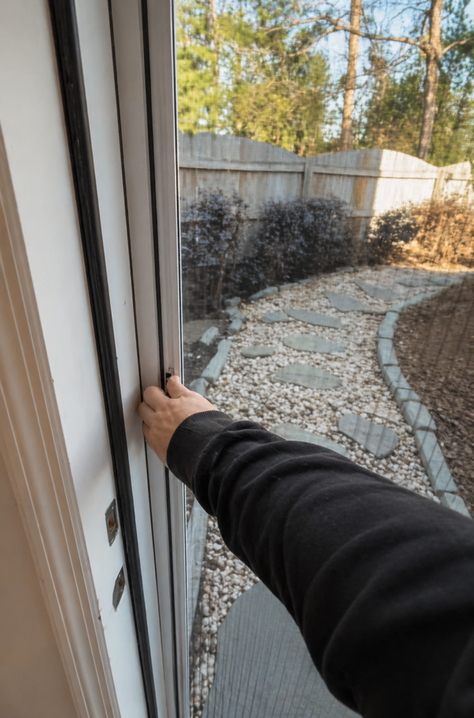 Installing mosquito screen on door frame close-up modern home AWDI Atlanta
