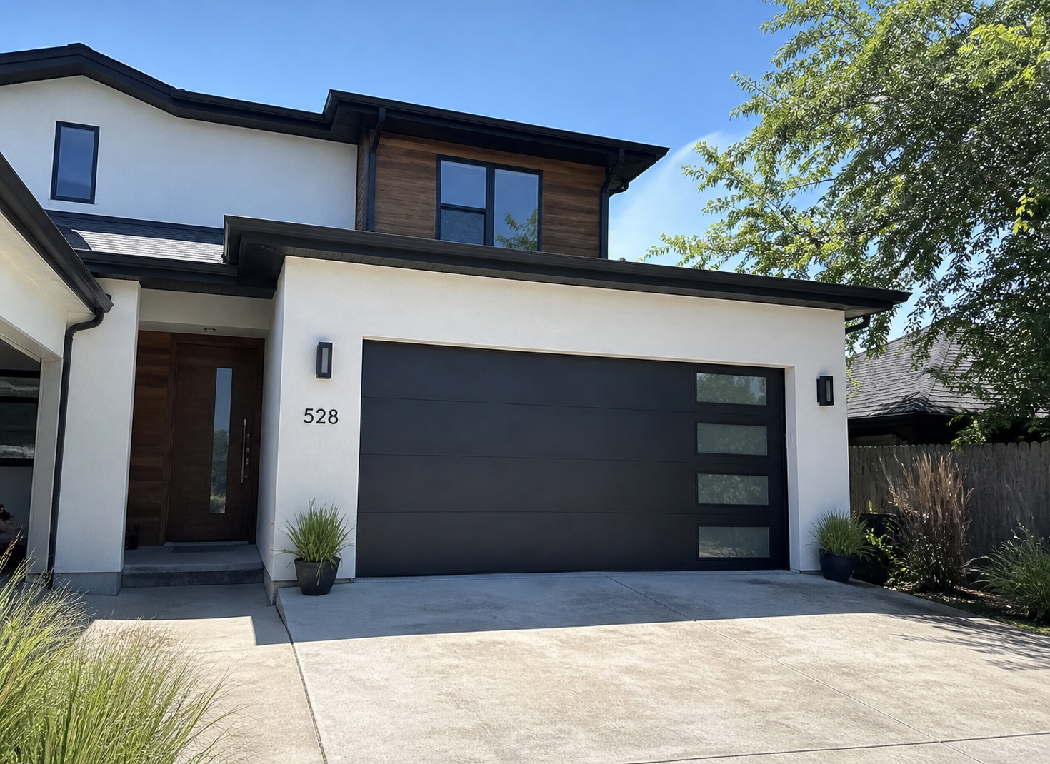 Modern aluminum sectional garage door installed on a contemporary home