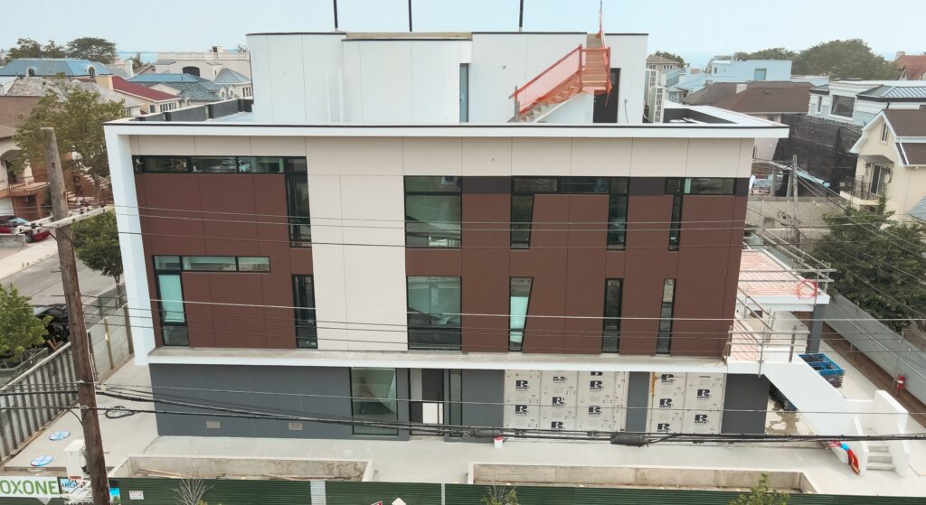 Avrams glass facade with aluminum windows and sliding doors on a private home in Manhattan Beach Brooklyn