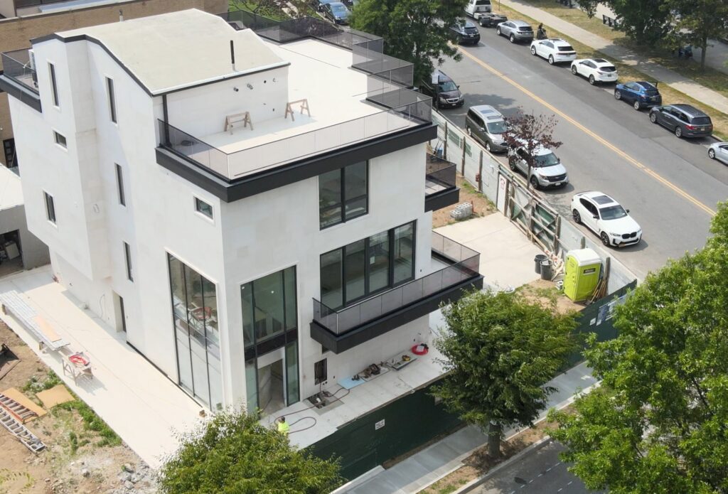 Avrams Windows and Doors project with aluminum windows, sliding doors, railings, and oceanfront home exterior in Brooklyn